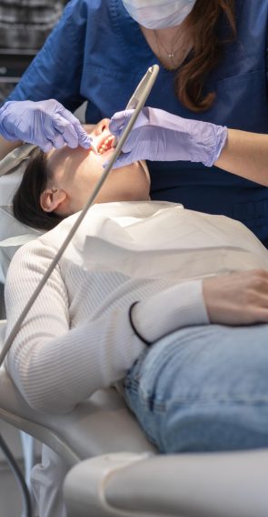 dentist-cleans-patients-mouth